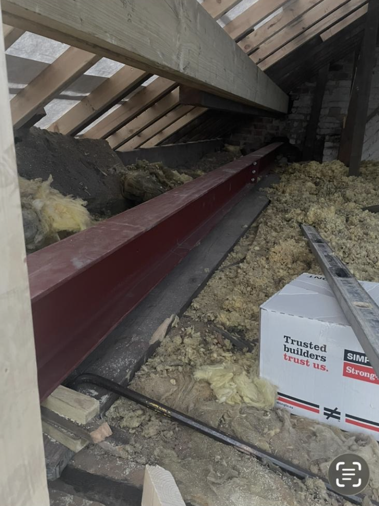 Red structural steel beam installed in a loft conversion