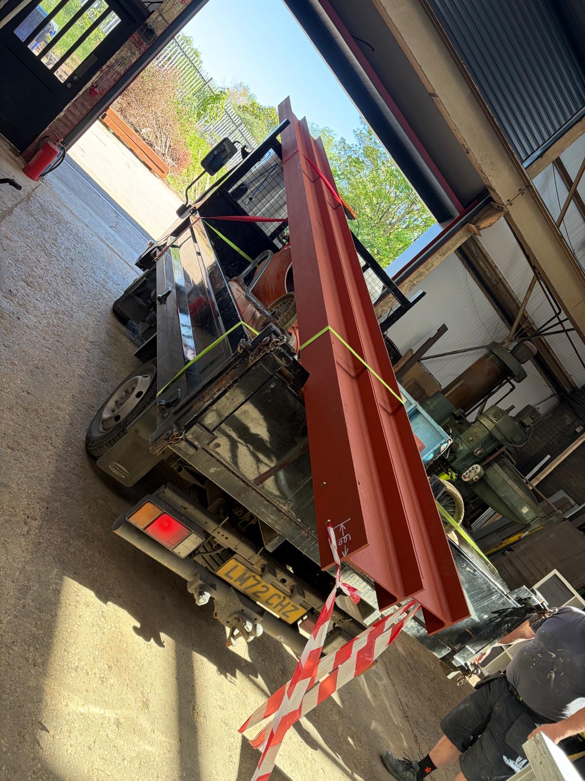 Red fabricated beams carried out of the workshop