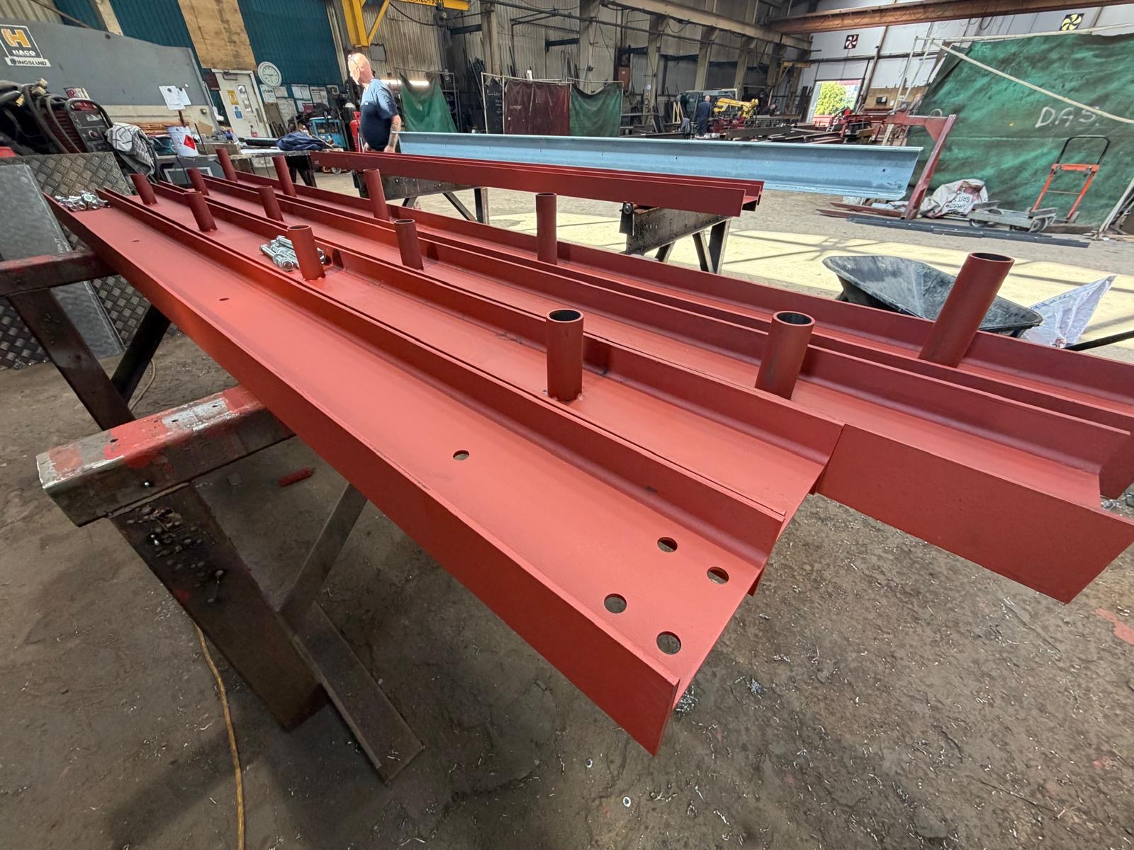 Red oxide painted purlins with welded tube cleats