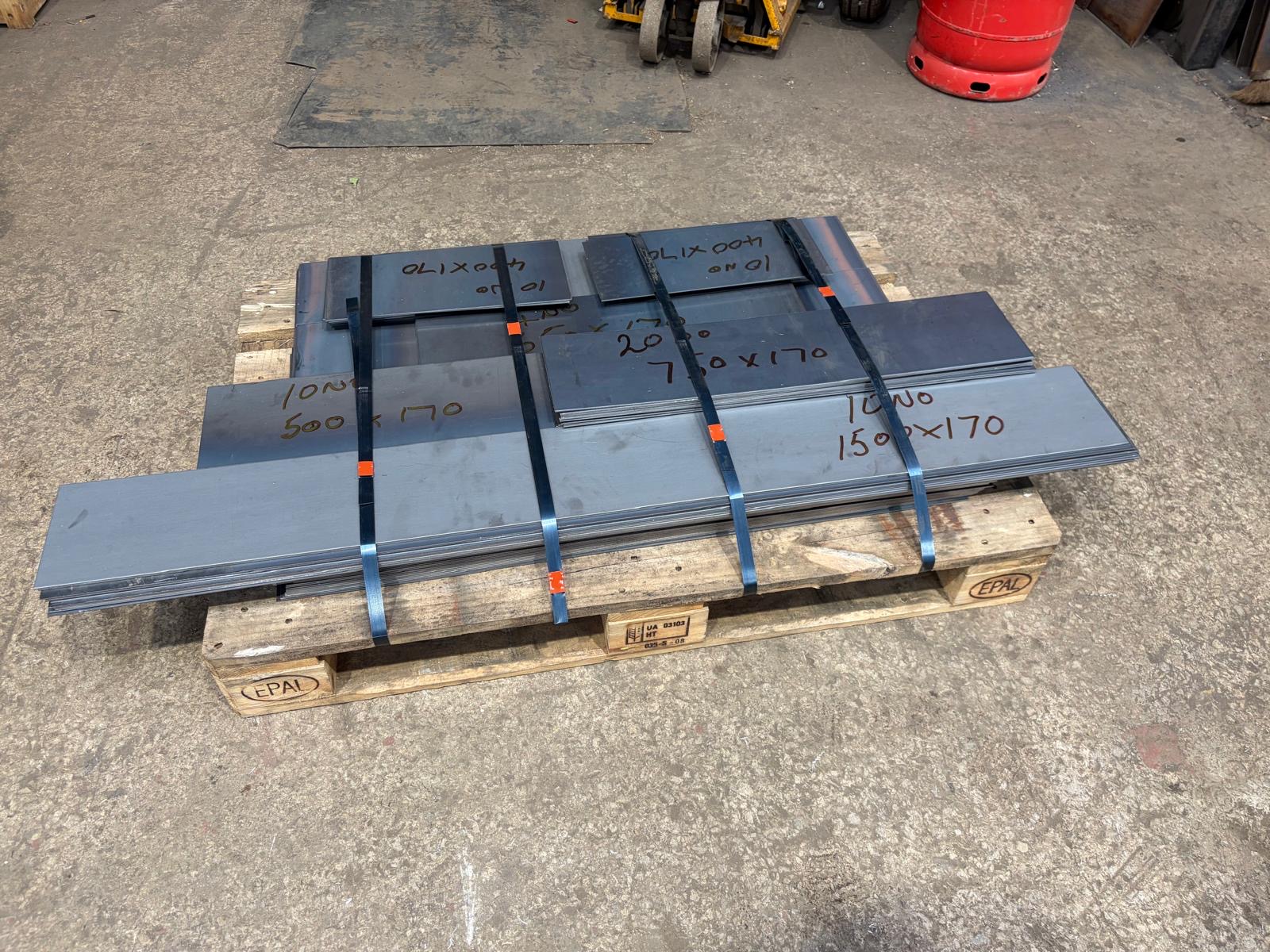 Cut and labelled steel plates strapped to a wooden pallet